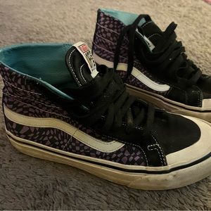 Purple and black checkered high top Vans